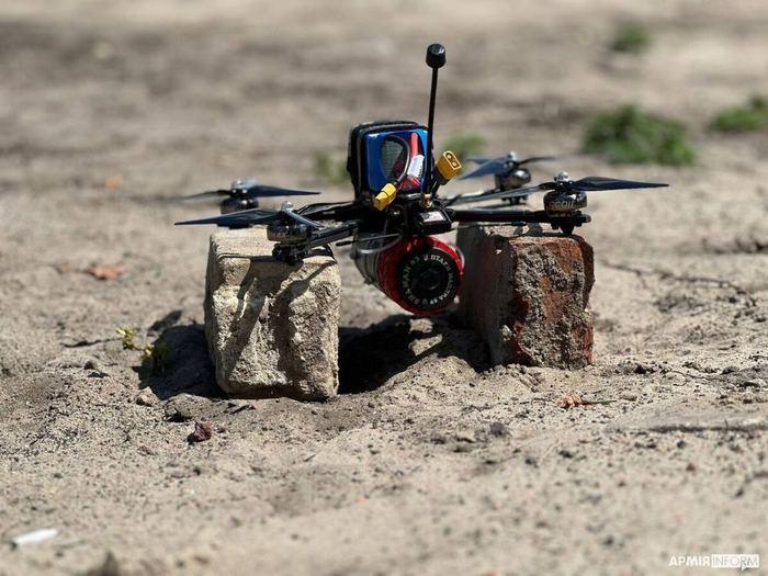 Ukrainian military FPV strike drone resting on bricks outdoors