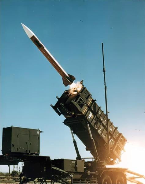 A Patriot missile launching against a clear sky